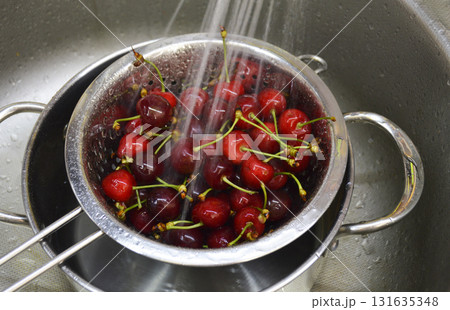 Washing fresh cherries under running water Washing fresh cherries under running water 131635348