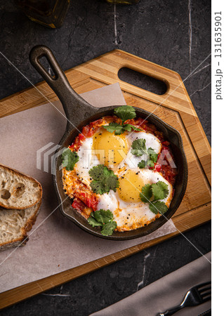 Shakshuka with poached eggs and vegetables 131635901
