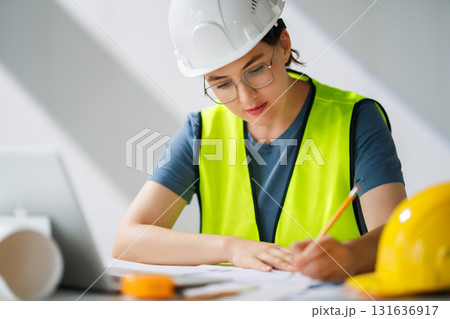 Woman architect is working on plans Woman architect is working on plans 131636917