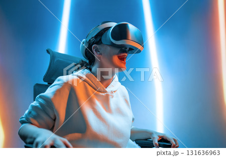Woman with VR virtual reality goggles 131636963