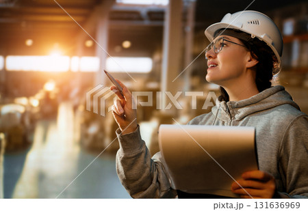 Young woman is working in warehouse 131636969
