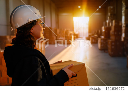 Young woman is working in warehouse Young woman is working in warehouse 131636972