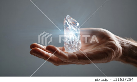 glowing quartz crystal cluster held in a hand glowing quartz crystal cluster held in a hand 131637284