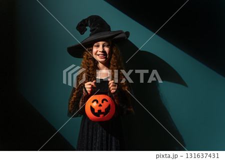 girl with Halloween pumpkin 131637431