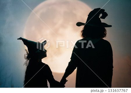 Woman and child holding a roast turkey together Woman and child holding a roast turkey together 131637767