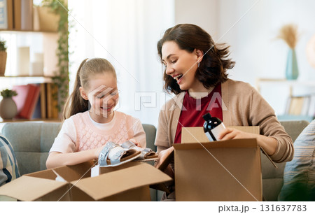 Woman and child holding a roast turkey together Woman and child holding a roast turkey together 131637783