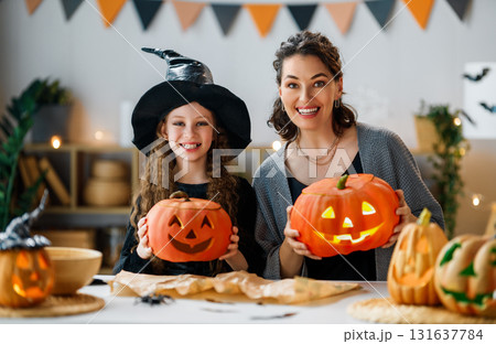 Woman and child holding a roast turkey together Woman and child holding a roast turkey together 131637784