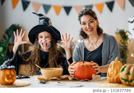 Woman and child holding a roast turkey together Woman and child holding a roast turkey together 131637789