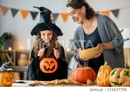 Woman and child holding a roast turkey together 131637790