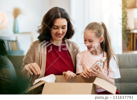 Woman and child holding a roast turkey together 131637791