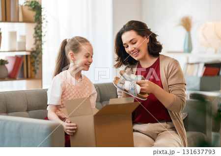 Woman and child holding a roast turkey together 131637793