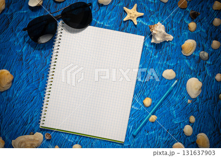 flat lay on blue background blank notebook copy space. summer plans concept flat lay on blue background blank notebook copy space. summer plans concept 131637903