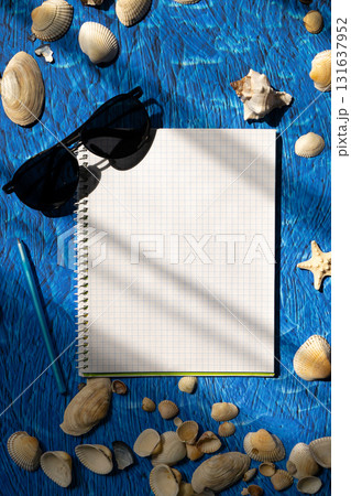flat lay on blue background blank notebook copy space. summer plans concept flat lay on blue background blank notebook copy space. summer plans concept 131637952