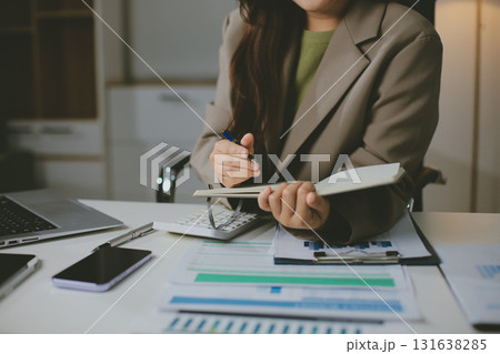 Portrait of young Hispanic professional business woman standing in office. Happy female company executive, smiling businesswoman entrepreneur corporate leader manager looking at camera using tablet Portrait of young Hispanic professional business woman standing in office. Happy female company executive, smiling businesswoman entrepreneur corporate leader manager looking at camera using tablet 131638285