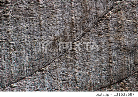 The dark texture of the wood resembles a frozen wave or a wrinkle of nature The dark texture of the wood resembles a frozen wave or a wrinkle of nature 131638697