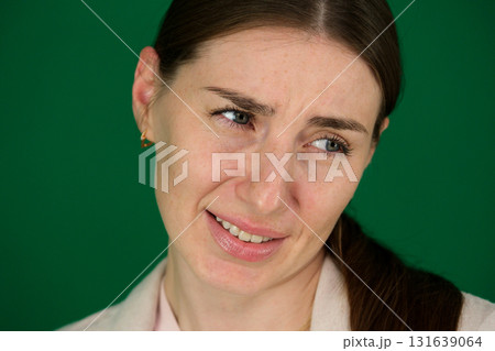 Set of photos of young European woman in light blazer and blue jeans showing various emotions gestures and expressions on green chroma key background with copy space for advertising and social media 131639064