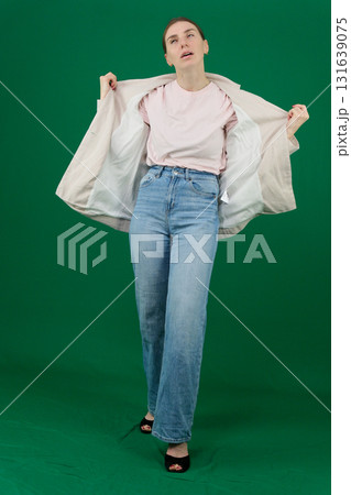 Set of photos of young European woman in light blazer and blue jeans showing various emotions gestures and expressions on green chroma key background with copy space for advertising and social media Set of photos of young European woman in light blazer and blue jeans showing various emotions gestures and expressions on green chroma key background with copy space for advertising and social media 131639075