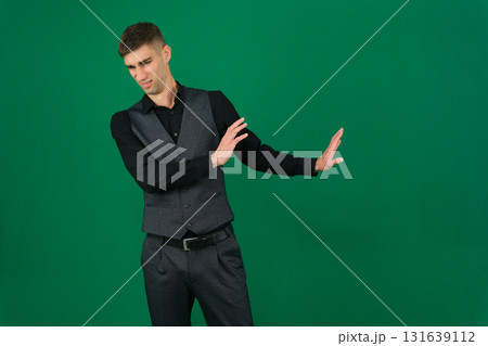 Set of videos with handsome European businessman in classic suit vest and black shirt showing different emotions gestures and confident poses on green chroma key background with copy space 131639112