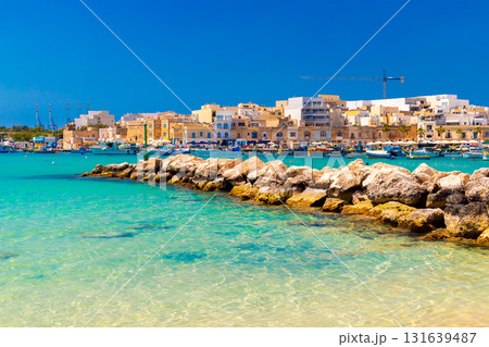Picturesque view of Marsaxlokk lagoon with turquoise sea water, a popular destination in Malta. Picturesque view of Marsaxlokk lagoon with turquoise sea water, a popular destination in Malta. 131639487
