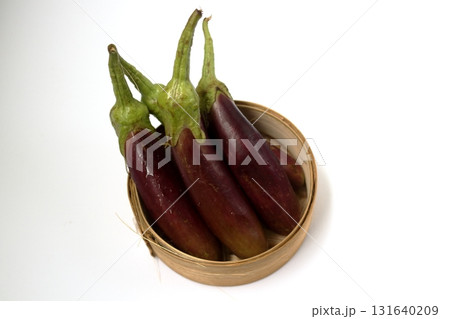 Group purple eggplant in bamboo basket. 131640209