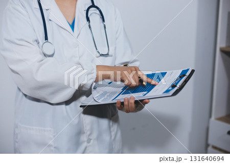 Portrait of female doctor, holding file 131640694
