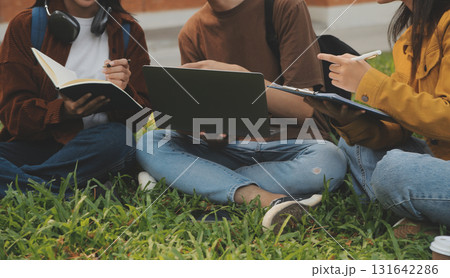 Happy students walking together on university campus, chatting and laughing outdoors after classes Happy students walking together on university campus, chatting and laughing outdoors after classes 131642286