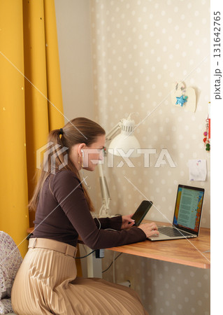 Woman working remotely at home Woman working remotely at home 131642765