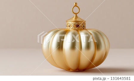 Shiny golden ribbed ornament displayed on a plain beige surface 131643581