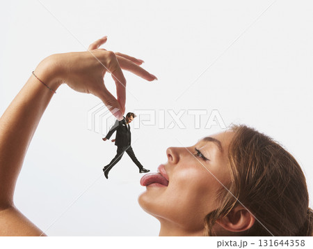 Woman holding tiny man above her tongue in surreal close-up collage Woman holding tiny man above her tongue in surreal close-up collage 131644358