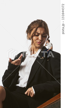 Creative collage. Businesswoman looking at tiny man sitting on her shoulder with confident expression Creative collage. Businesswoman looking at tiny man sitting on her shoulder with confident expression 131644372