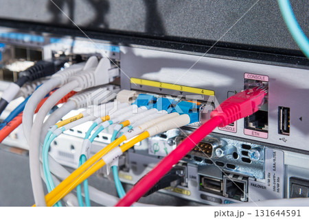 Fiber Optic cables connected to optic ports, network cables conn 131644591