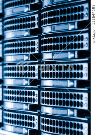 Cluster of data storage hard drives inside server room 131644595