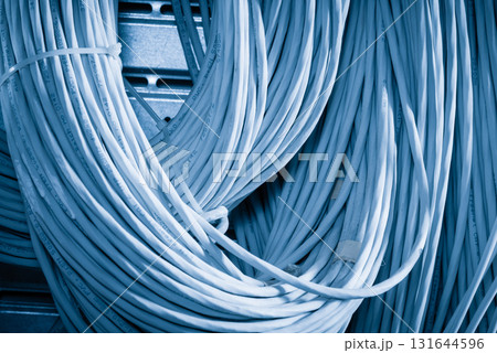 bunch of network cables in wave pattern leading across server ro 131644596