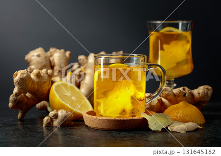 Ginger tea with lemon on a black background. 131645182