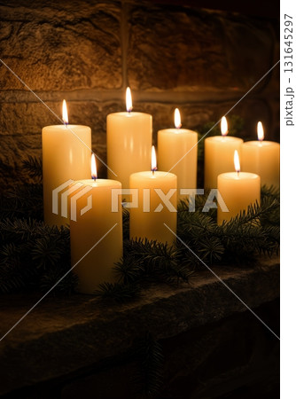 Cozy Hygge Christmas Fireplace Mantel with Glowing Pillar Candles and Evergreen Garland 131645297