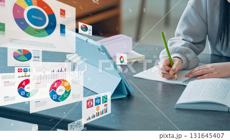 タブレットを見ながら勉強する女の子と統計データ 131645407