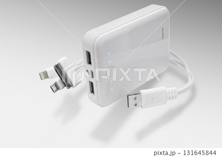 Power bank for smartphones, compact and efficient, presented against a white-gray background , perfect for everyday charging at home or on the go. 131645844