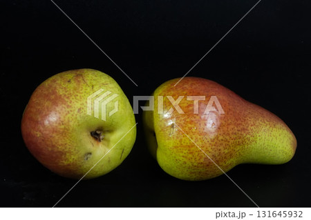 Colorful Forelle pears pop against a dark backdrop, highlighting their unique speckled skin and fresh appeal. Colorful Forelle pears pop against a dark backdrop, highlighting their unique speckled skin and fresh appeal. 131645932