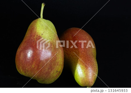 Colorful Forelle pears pop against a dark backdrop, highlighting their unique speckled skin and fresh appeal. Colorful Forelle pears pop against a dark backdrop, highlighting their unique speckled skin and fresh appeal. 131645933