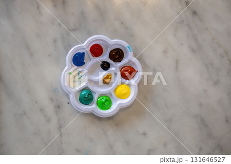 Colorful paint palette with various bright colors on marble surface 131646527