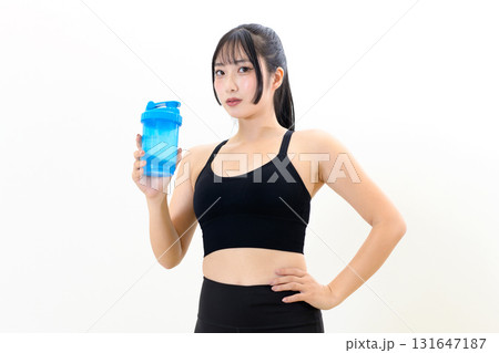 プロテインシェイカーを持つ、体を鍛えてるかっこいい女性　　筋トレ女子　白バック　トリミングアップ 131647187