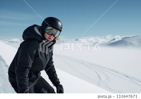 Snowboarder stands calmly on snowy slope under vast clear blue sky Snowboarder stands calmly on snowy slope under vast clear blue sky 131647671