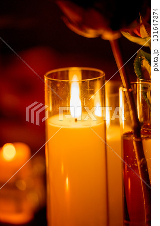 Row of warm yellow LED candles in candle holders for event decor in the dark 131647874