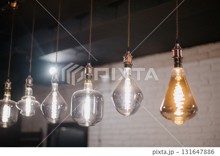 A row of vintage Edison pendant lamps in various shapes A row of vintage Edison pendant lamps in various shapes 131647886