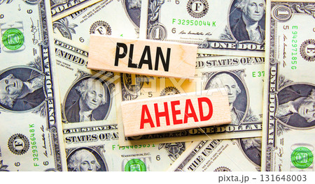 Plan ahead symbol. Concept word Plan ahead on beautiful wooden blocks. Dollar bills. Beautiful dollar bills background. Business plan ahead concept. Copy space. 131648003