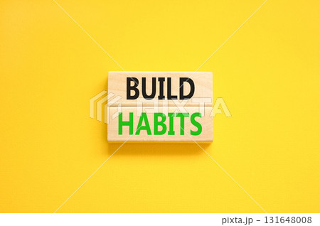 Build habits symbol. Concept word Build habits on beautiful wooden blocks. Beautiful yellow paper background. Business build habits concept. Copy space. Build habits symbol. Concept word Build habits on beautiful wooden blocks. Beautiful yellow paper background. Business build habits concept. Copy space. 131648008