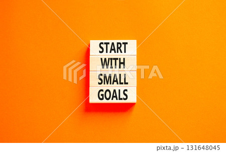 Start with small goals symbol. Concept words phrase Start with small goals on beautiful wooden blocks. Beautiful orange paper background. Business Start with small goals concept. Copy space. 131648045