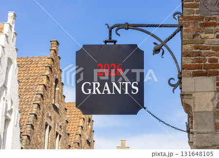 2026 Grants symbol. Concept words 2026 Grants on beautiful black road sign. Beautiful street and buildings in Brugge blue sky background. Business and 2026 grants concept. Copy space. 131648105