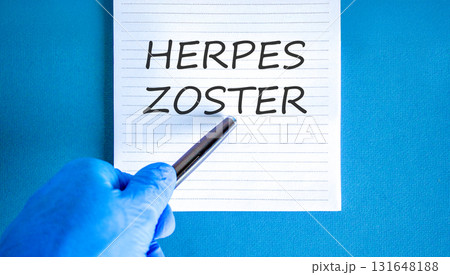 Herpes zoster symbol. Concept words Herpes zoster on beautiful white note. Doctor's hand in blue medical glove. Black pen. Beautiful blue background. Medical healthy lifestyle herpes zoster concept 131648188