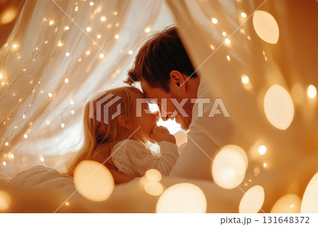 A parent and child cuddling and reading bedtime stories together under cozy blankets in a warm intimate bedroom setting filled with soft lighting and a sense of love and connection 131648372